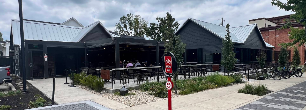 The indoor-outdoor pergola and patio seating at The Goat overlooking the Monon Trail in Midtown Carmel
